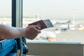 Closeup of male holding passports and boarding pass