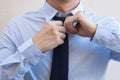 Closeup of Male office worker tying a tie