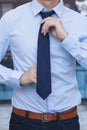 Closeup of Male office worker tying a tie