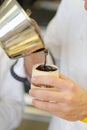 Closeup of a male pastry chef decorating dessert