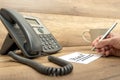 Closeup of male receptionist writing the word Urgent