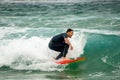 Closeup of a male surfer at Bondi beach catching waves and having a great time