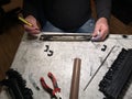 Closeup of the male technician's hands repairing the printer