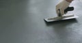 Closeup male worker applying micro concrete plaster coating on the floor with a trowel Royalty Free Stock Photo