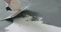 Closeup male worker applying micro concrete plaster coating on the floor with a trowel