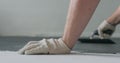 Closeup male worker applying micro concrete plaster coating on the floor with a trowel Royalty Free Stock Photo