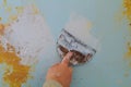 Closeup of a man aligning a wall with spatula and trowel. Royalty Free Stock Photo