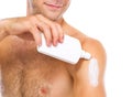 Closeup on man applying sun block creme on arm Royalty Free Stock Photo