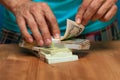 Closeup of man counting currency heaps. Royalty Free Stock Photo