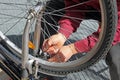 Closeup of a man, doing bicycle repairs and mainte