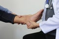 Closeup of Man feeling pain in her foot and doctor the traumatologist examines or treatment on white background, Healthy concept Royalty Free Stock Photo