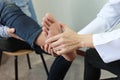 Closeup of Man feeling pain in her foot and doctor the traumatologist examines or treatment on white background, Healthy concept Royalty Free Stock Photo