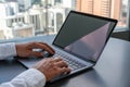 Closeup man fingers typing on the laptop keyboard, city view and mock up display Royalty Free Stock Photo