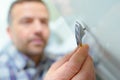 Closeup man fixing handle on cupboard Royalty Free Stock Photo