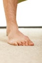 Closeup of man foot standing on carpet Royalty Free Stock Photo