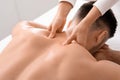 Closeup of man getting acupressure massage at spa salon