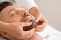 Closeup of man getting healing face massage at spa Royalty Free Stock Photo