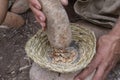 Grinding acorns with stone mortar and pestle Royalty Free Stock Photo