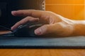 Closeup of man hand clicking computer mouse and flare light Royalty Free Stock Photo