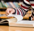 Closeup man hand going to flip page of book