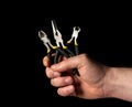 Closeup of a man hand holding diagonal pliers and pincers tool on black background. Commonly used to repair electricity Royalty Free Stock Photo