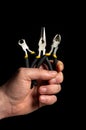 Closeup of a man hand holding diagonal pliers and pincers tool on black background. Commonly used to repair electricity Royalty Free Stock Photo
