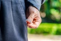 Man hand put in or taking out a wedding ring in the worn pocket. Concept of infidelity or asking in marriage. Royalty Free Stock Photo