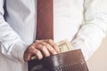 Closeup of man hands count us dollar money, male hand putting money in the wallet, light and business concept Royalty Free Stock Photo