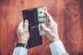 Closeup of man hands count us dollar money, male hand putting money in the wallet Royalty Free Stock Photo