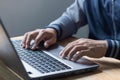 Closeup man hands typing on a computer laptop keyboard, businessman or student using laptop at home, online learning, internet Royalty Free Stock Photo