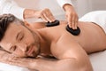 Closeup of man having hot stone massage at luxury spa Royalty Free Stock Photo