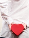 Closeup of man with heart shaped gift box. Royalty Free Stock Photo