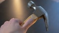 Closeup of a man holding a framing hammer on a grey background Royalty Free Stock Photo