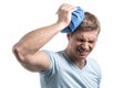 Closeup of man holding icepack on his head. Royalty Free Stock Photo