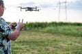 Closeup of a man holding a remote control of a drone, Flying drone on background. Selective focus Royalty Free Stock Photo