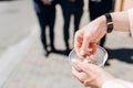 Closeup of man holding rice bowl to throw at married couple, old european wedding tradition concept Royalty Free Stock Photo