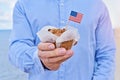 Closeup man holds cupcake with American flag of USA Royalty Free Stock Photo