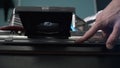 Closeup of Man Inserting Disc into DVD Player