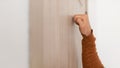 Closeup of man knocking on the wooden door Royalty Free Stock Photo