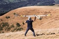 Closeup of a man launches a radio-controlled model glider during an aircraft modeling competition