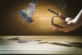 Closeup of man magician with two playing cards in his hand over grey background Royalty Free Stock Photo