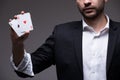 Closeup of man magician with two playing cards in his hand Royalty Free Stock Photo