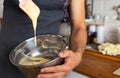 Closeup of a man mixing dough in a bowl in the kitchen