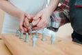 Closeup of man in occupational therapy screwing nut on bolt Royalty Free Stock Photo