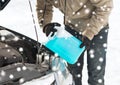 Closeup of man pouring antifreeze into car