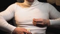 Closeup of a man pouring a lot of round vitamins on his hand from a jar and putting them in his mouth Royalty Free Stock Photo