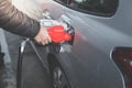Closeup of man pumping gasoline fuel in car at gas station. Royalty Free Stock Photo