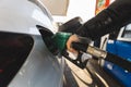 Closeup of man pumping gasoline fuel in car at the gas station, car concept Royalty Free Stock Photo