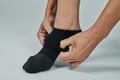 man putting on a compression sock