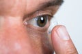 Closeup Of Man Putting Contact Lens In Eye Royalty Free Stock Photo